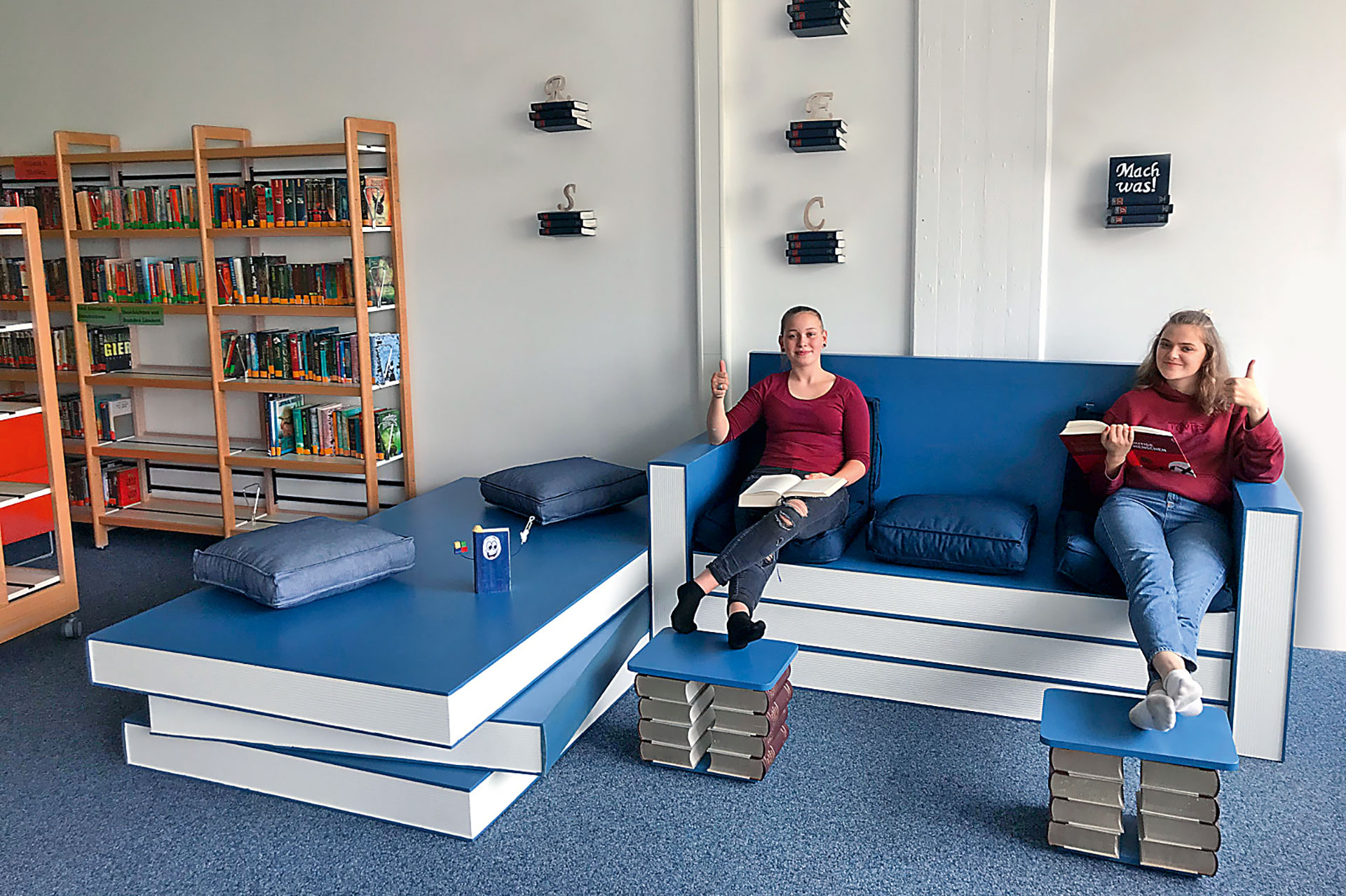 Ninth-grade students from Realschule Neustadt bei Coburg build seating made to look like books for their school library.